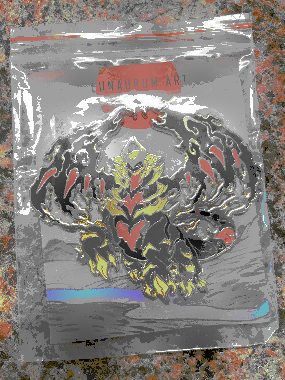 A metallic pin of Giratina from Pokemon